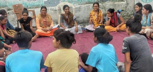 Young people and adults meet in a local parliament